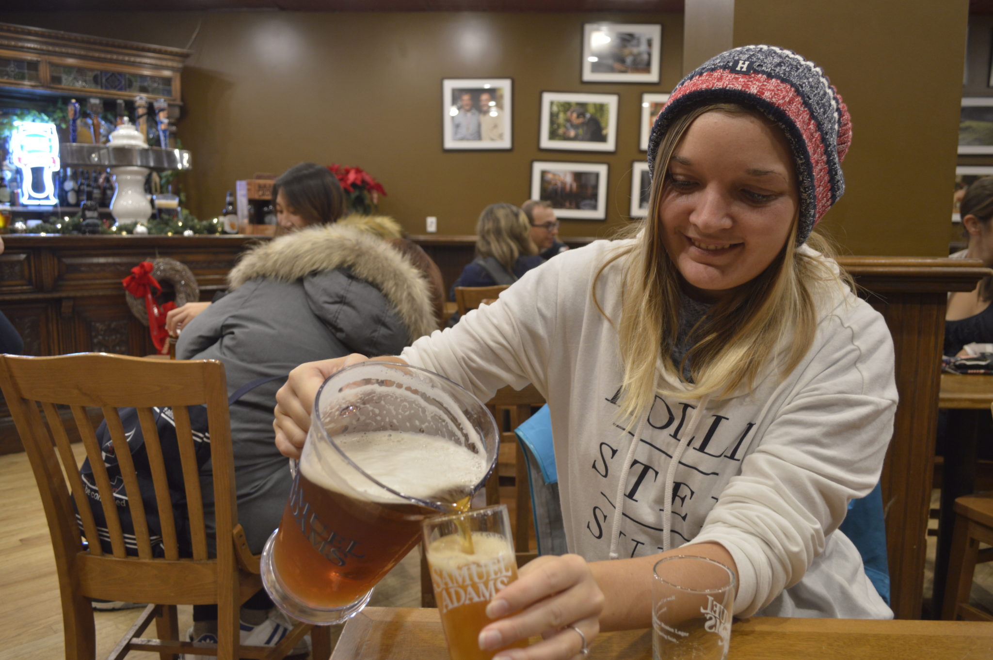 Photograph of someone pouring free beer in the sample room in the Sam Adams brewery