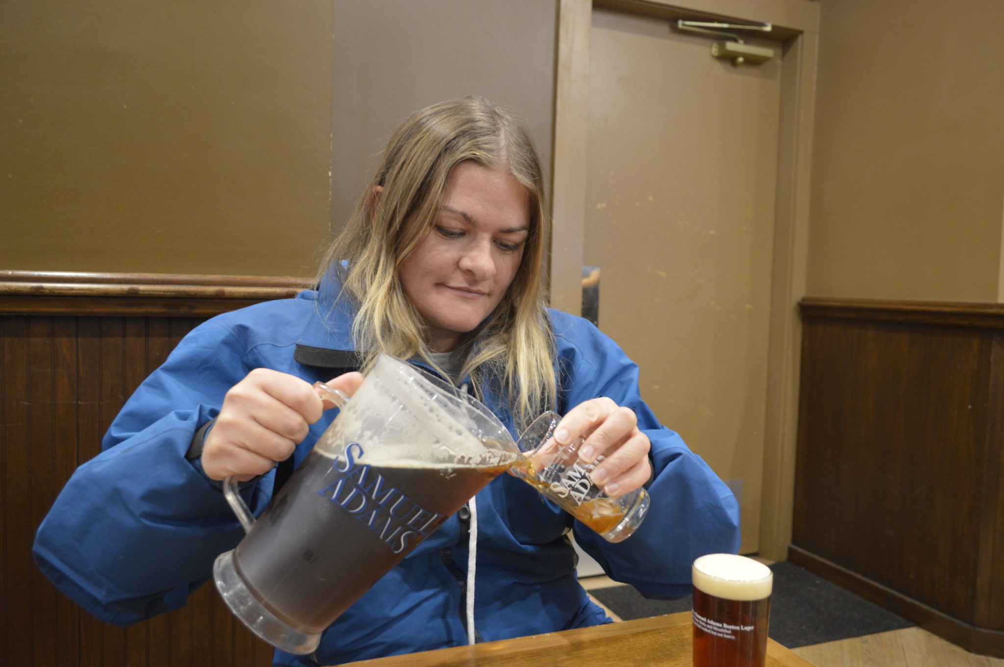 Photograph of someone pouring free beer in the Samuel Adams brewery sample room