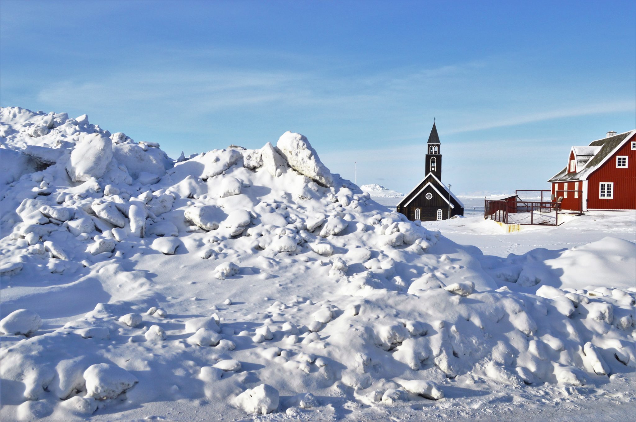 Big snow pile in front of a church in Ilulissat Greenland