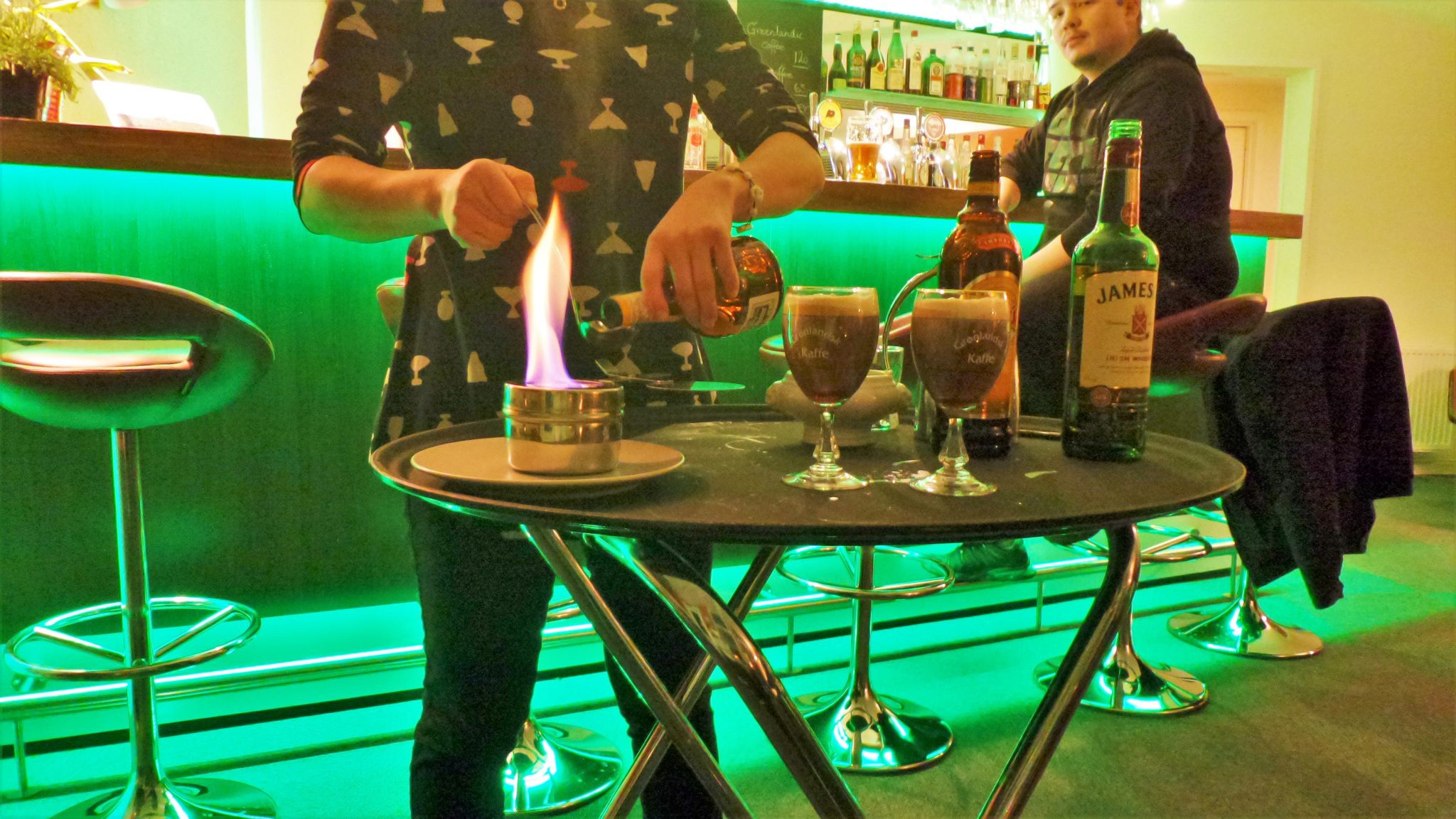 Picture of added whipped cream into a Greenlandic Coffee while warming up the Grand Mariner