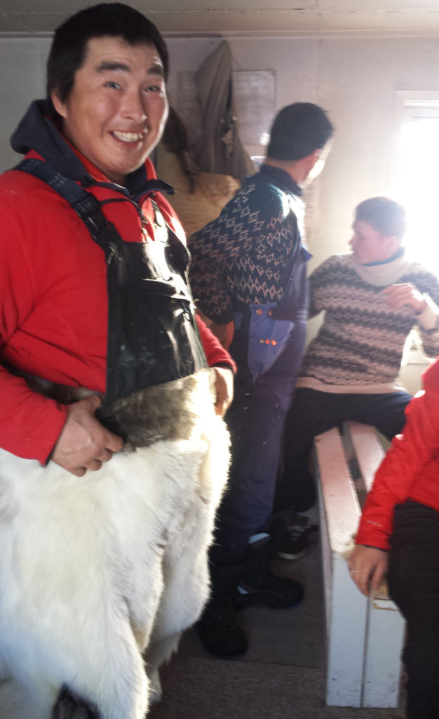 Greenlandic wearing Polar Bear Trousers on dog sledding expedition in the Arctic Circle