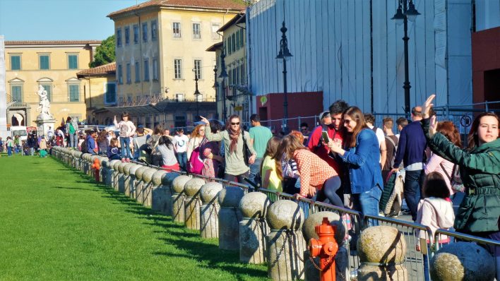 Tourists at the Leaning Tower of Pisa posing, Italy